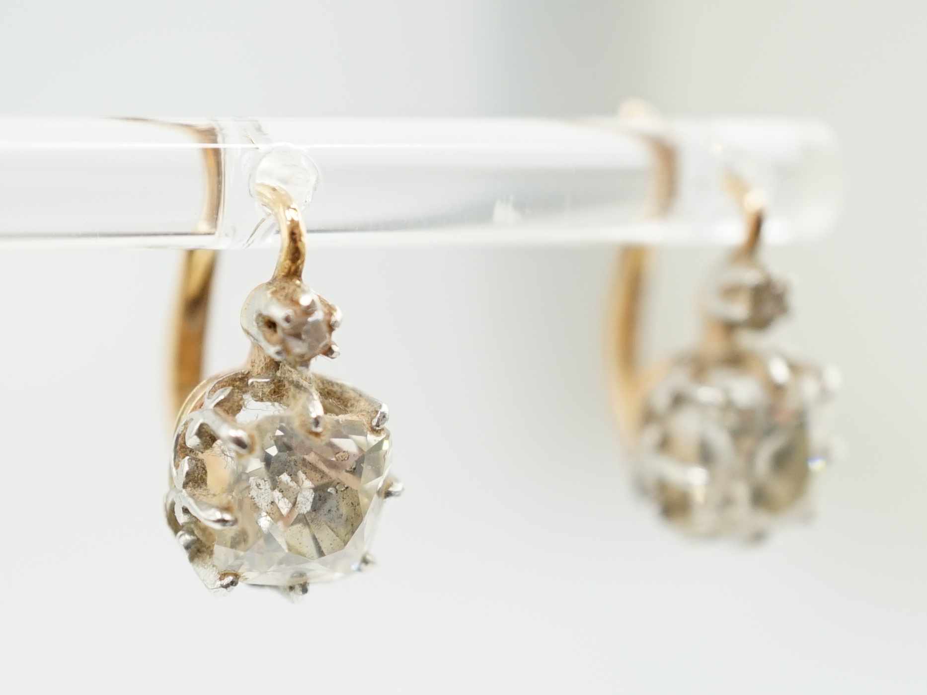 A pair of late 19th/early 20th century gold and two stone cushion cut diamond set earrings